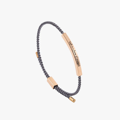 Bracelet with rose gold tags and gray braided cord on a white background